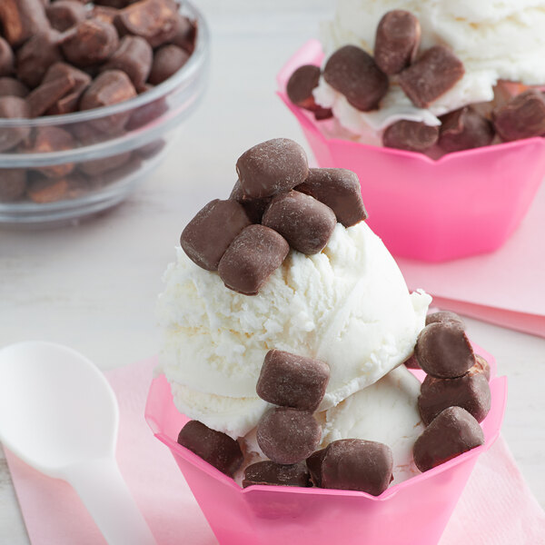 A bowl of ice cream with Milk Chocolate Mini Marshmallow Topping and a spoon.