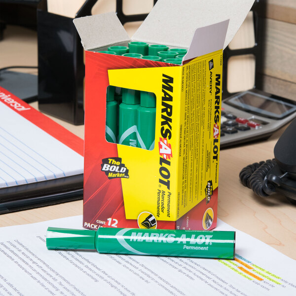 A box of Avery Marks-A-Lot green permanent markers on a desk.