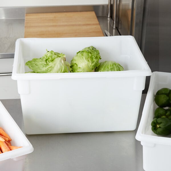 A white Rubbermaid food storage box on a kitchen counter with containers of bell peppers and lettuce inside.