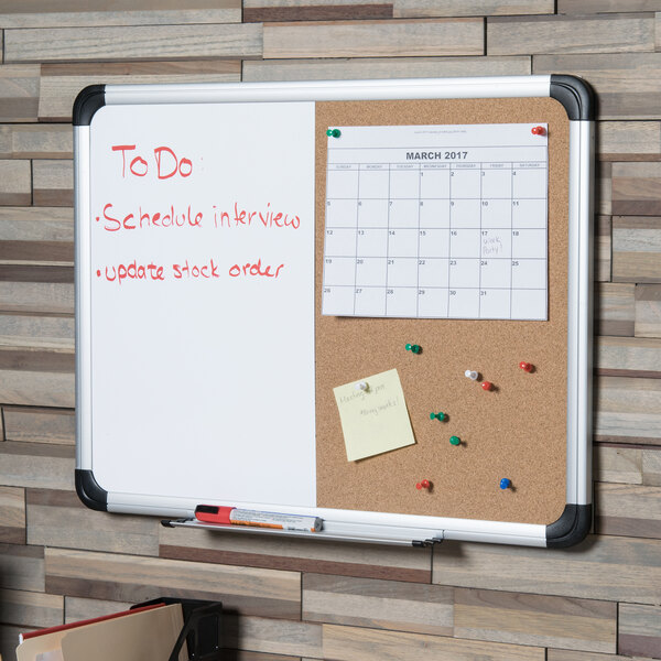 A white Universal two panel board with a dry erase board and cork board with a calendar and notes on it.