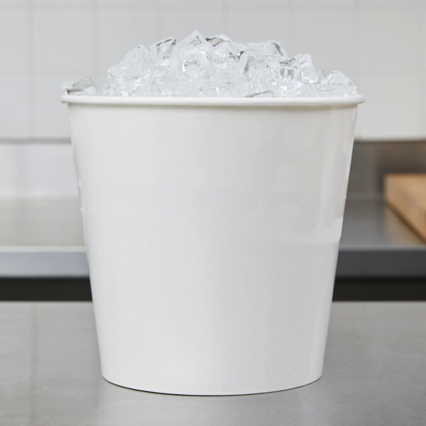 A white Lavex paper ice bucket filled with ice on a counter.
