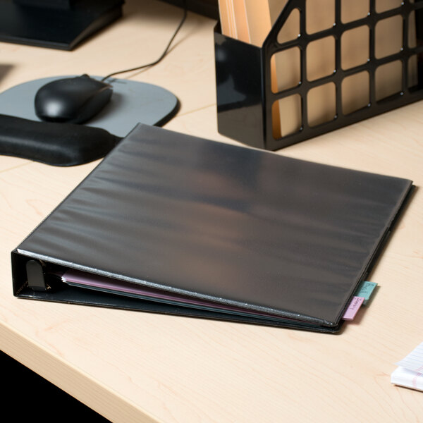 An Avery black heavy-duty view binder on a desk.