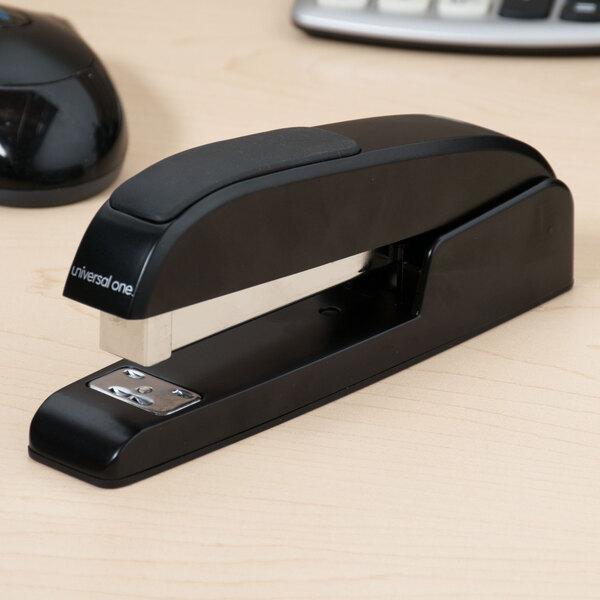 A black Universal executive stapler on a desk.