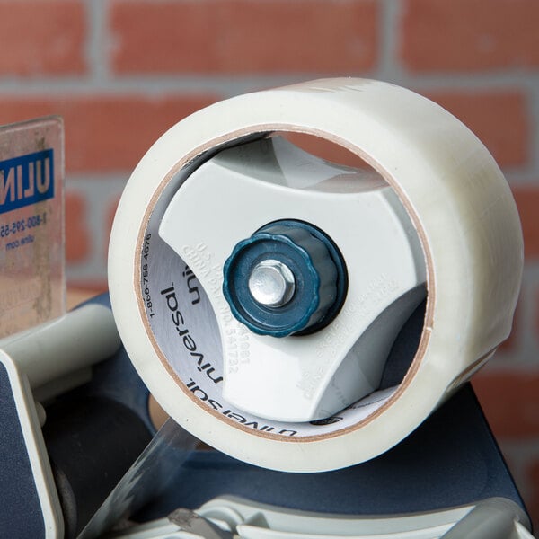 A Universal One clear tape dispenser with a blue wheel.