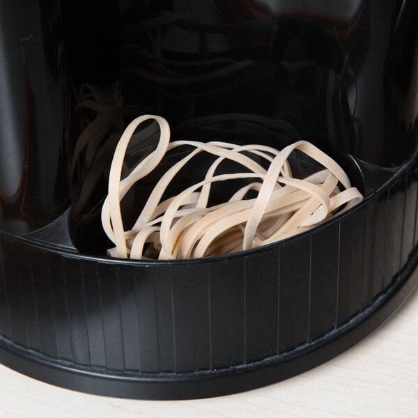 A black container with a white Universal beige rubber band inside.