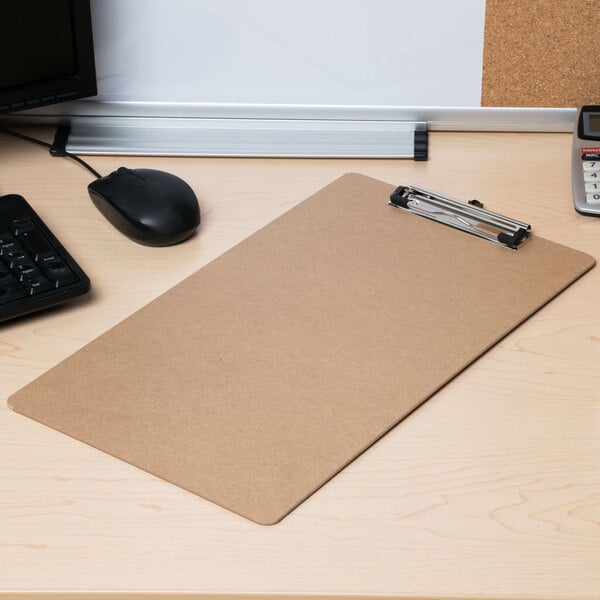 A brown Universal clipboard on a desk with a black computer mouse.