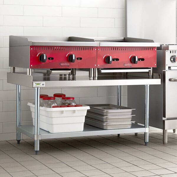 A Regency stainless steel equipment stand in a large commercial kitchen.
