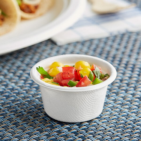 A small white EcoChoice portion cup filled with vegetables.