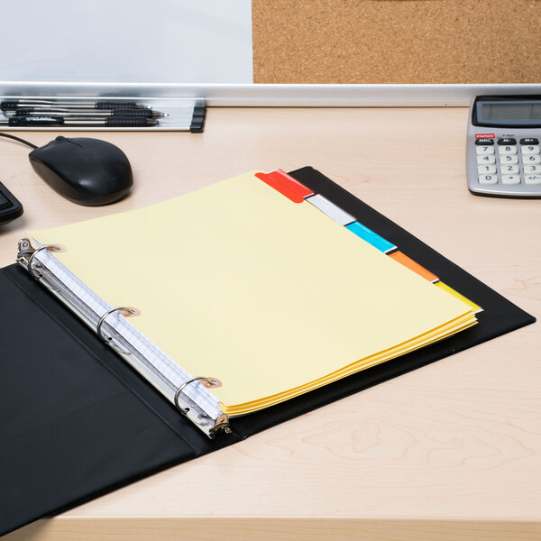A file folder with Avery Big Tab dividers in a binder with yellow papers on a desk.