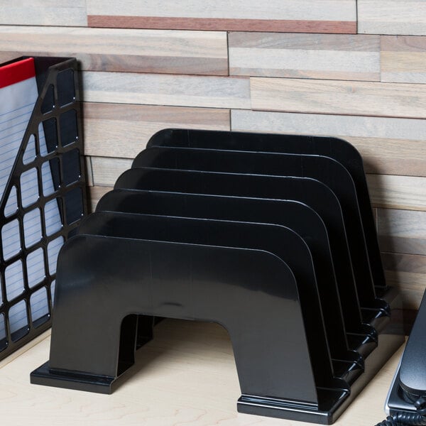 A black plastic Universal incline sorter on a table with a phone and paper holder.