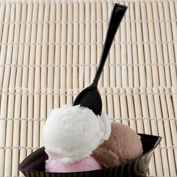 A bowl of ice cream with a black Fineline Tiny Tasters tasting spoon.