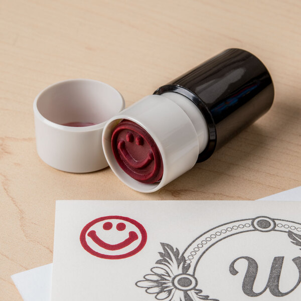 A Universal red round pre-inked smiley face stamp.