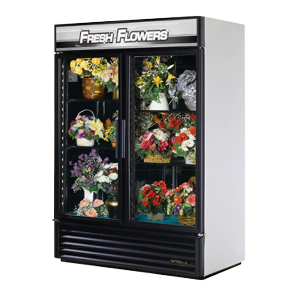 A True refrigerated glass door floral case with flowers inside.