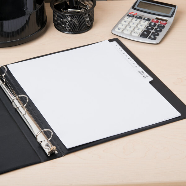 A binder with Avery Premium Collated Table of Contents Dividers on a white sheet of paper on a table with a calculator.