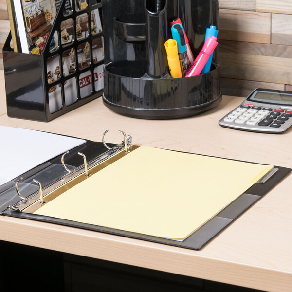 A Universal binder with Universal extended length clear tab dividers holding yellow paper.
