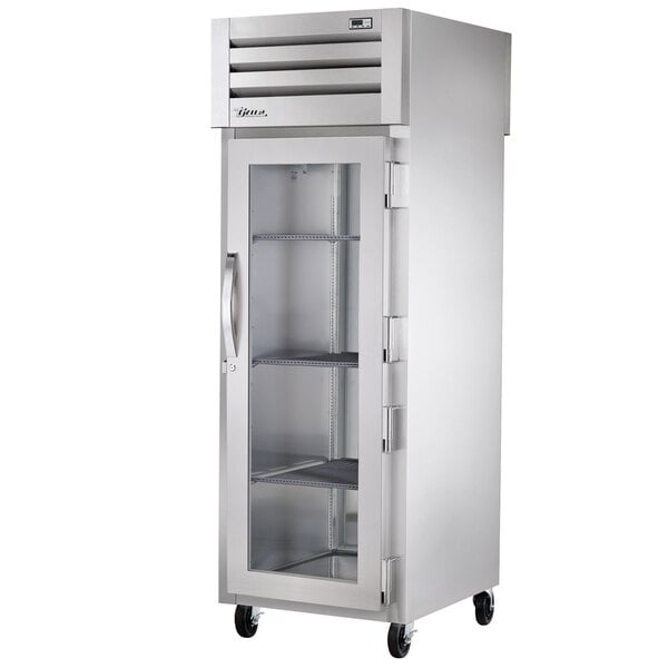 A True Spec Series pass-through refrigerator with a glass door and metal cabinet.