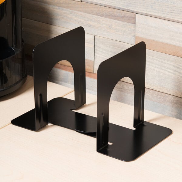 A pair of black metal Universal bookends on a wood surface.