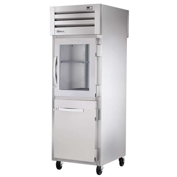 A True commercial pass-through refrigerator with half glass and solid doors.
