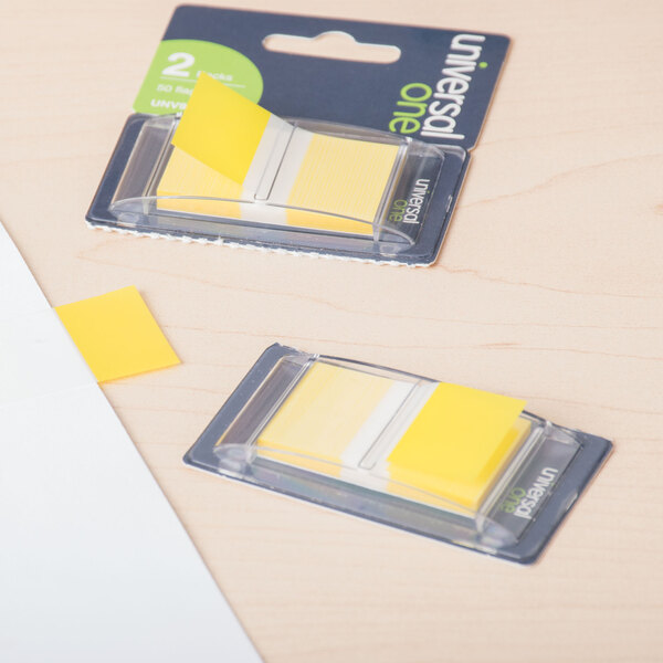 A package of two yellow Universal 1" x 1 3/4" sticky page flags.