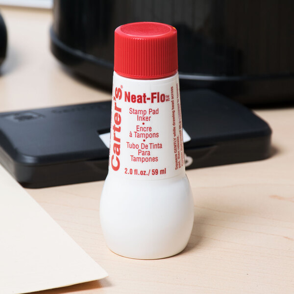 A white bottle of Avery Neat-Flo ink with a red cap and label.