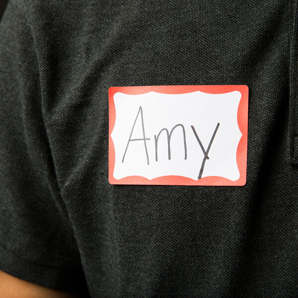 A person wearing an Avery red bordered name tag.