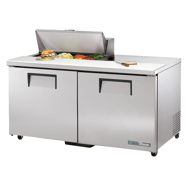 A True ADA height stainless steel commercial sandwich prep table with food on top.