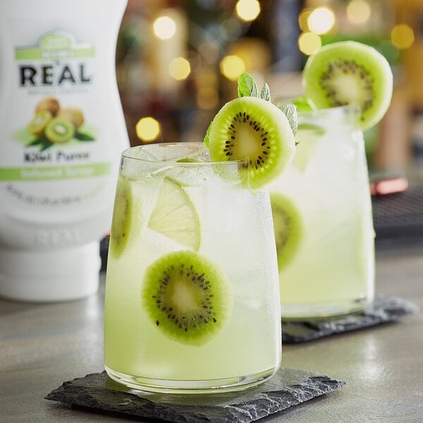 Two glasses of kiwi juice with Real Kiwi Puree Infused Syrup on a table.