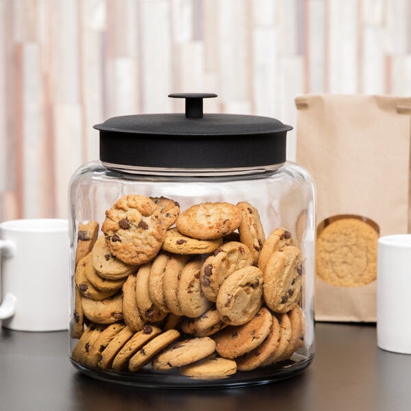 An Anchor Hocking Montana jar filled with cookies on a table.