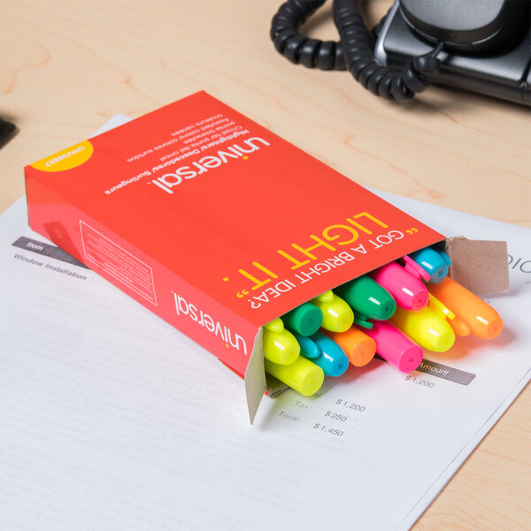 A box of Universal chisel tip highlighters in assorted colors on a desk.
