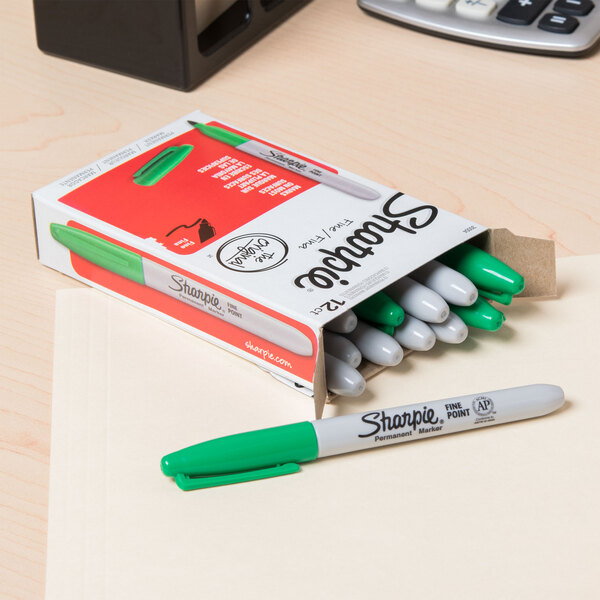 A box of Sharpie green fine point markers on a table.
