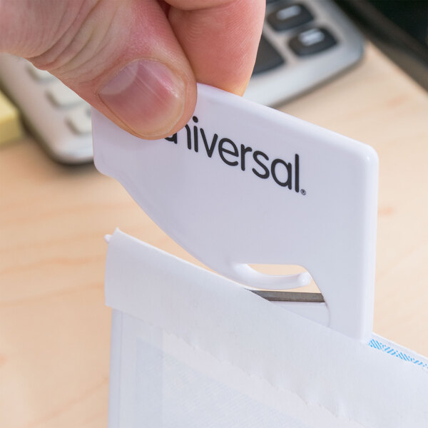 A hand using a Universal white concealed blade letter slitter to open a white envelope.