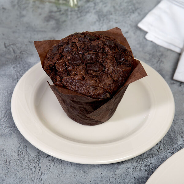 A chocolate muffin on a Homer Laughlin Lyrica Ivory China plate.