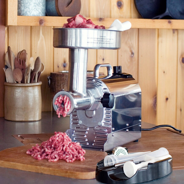 A Weston Pro Series electric meat grinder on a cutting board.