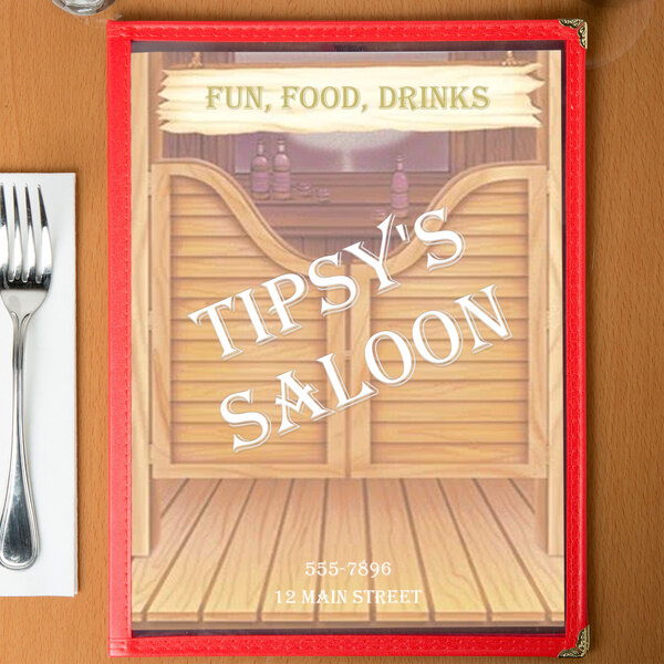 A Southwest saloon themed menu on a table with a glass of wine.