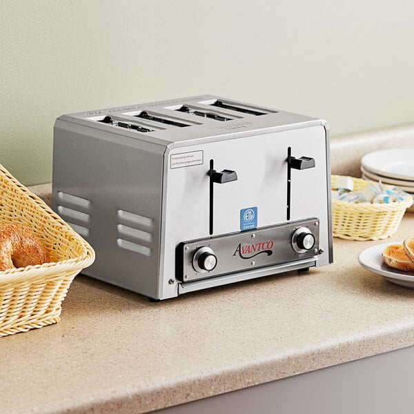 An Avantco commercial toaster with four slots on a counter with bread.