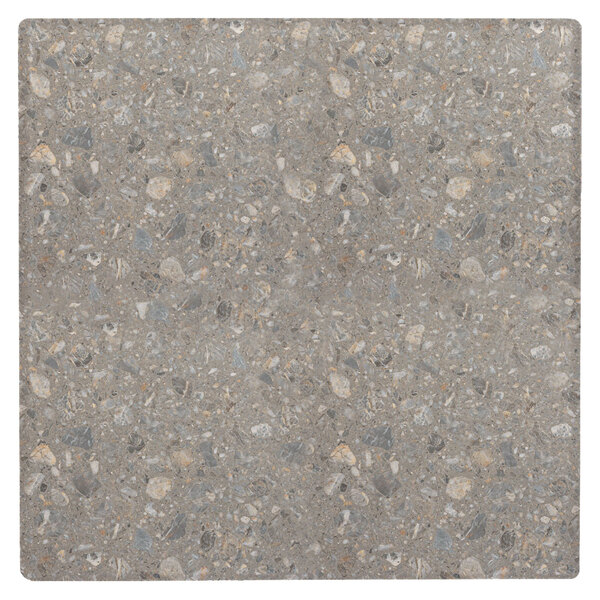 A Grosfillex Tokyo Stone table top with a gray tile pattern with small rocks and pebbles.