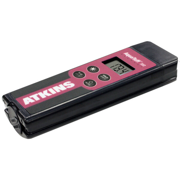 A pink and black Cooper-Atkins AquaTuff digital temperature tester with buttons and a display.