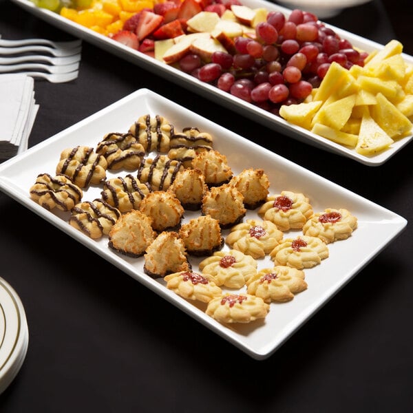 An American Metalcraft trapezoid melamine serving platter with food on a table.