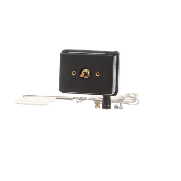 A black electrical switch with a gold knob and a white cord.
