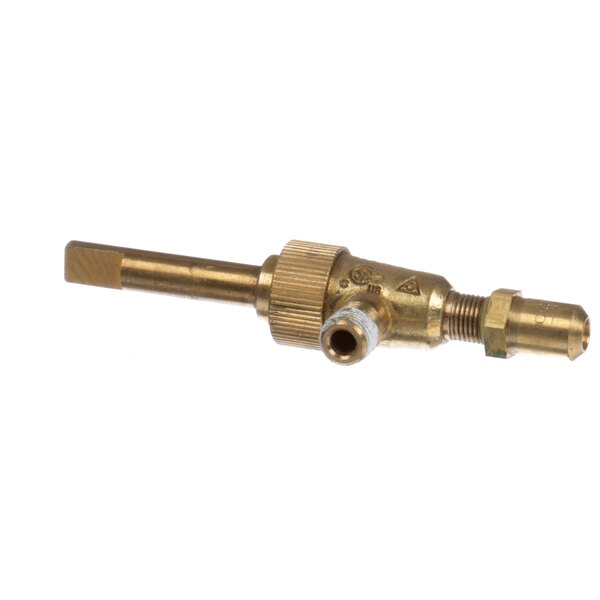A close-up of a brass Montague top burner valve with a small hole in it.