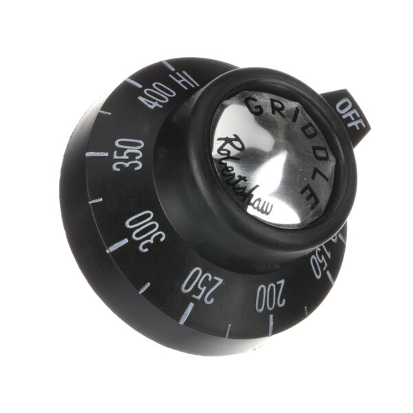 A close-up of a black Southbend knob with white numbers.