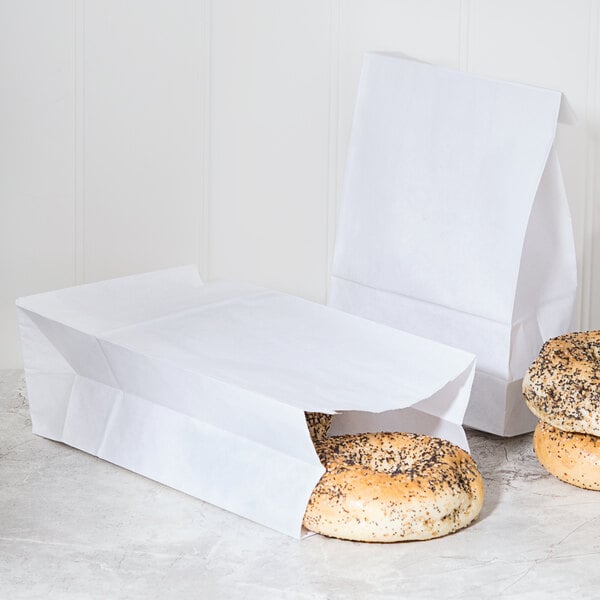 A Duro white paper bag filled with bagels.