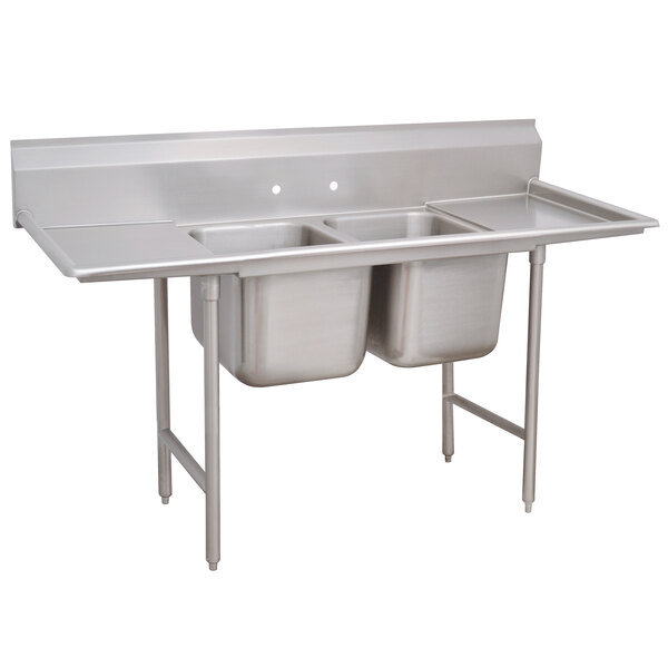 An Advance Tabco stainless steel pot sink with two compartments and two drainboards.