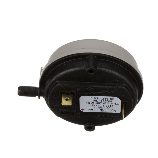 A close-up of a small round black and white Cleveland Air Prover pressure switch.
