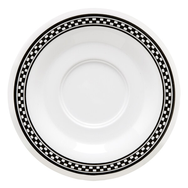 A white saucer with black and white diamond checkered design.