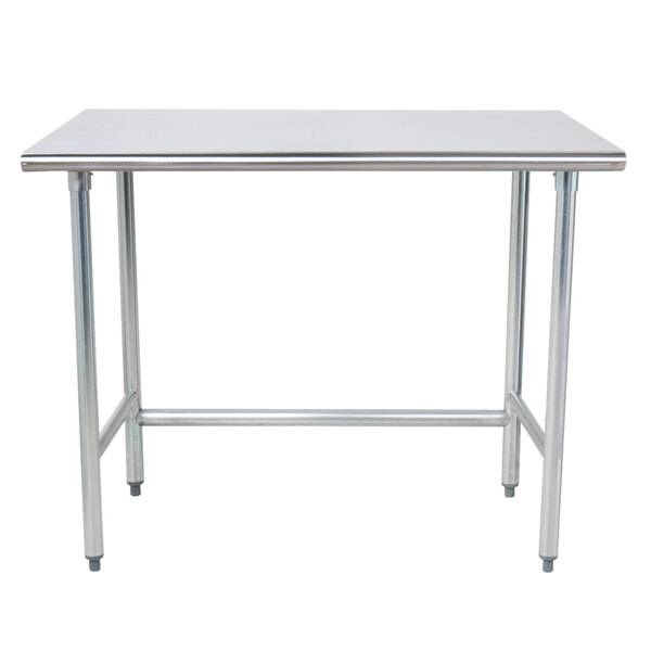 An Advance Tabco stainless steel work table with an open base on metal legs.