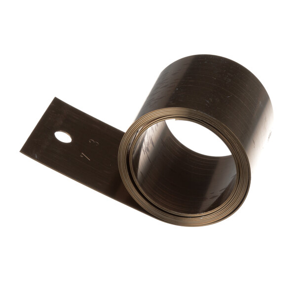 A roll of brown metal tape with a hole in it.