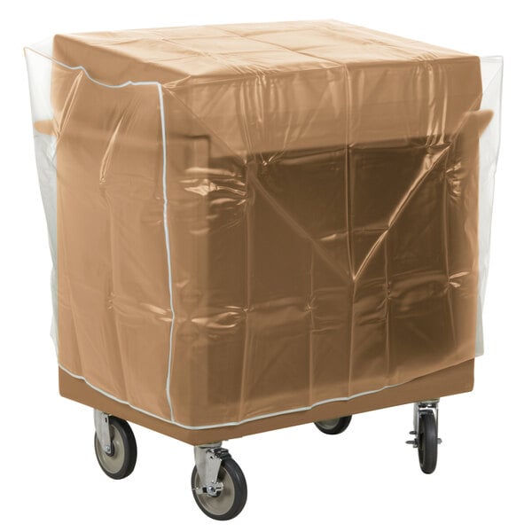 A plastic wrapped box on a Cambro coffee beige tray and dish cart.