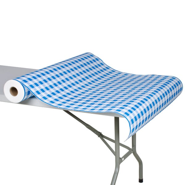 A roll of blue and white checkered paper on a table.