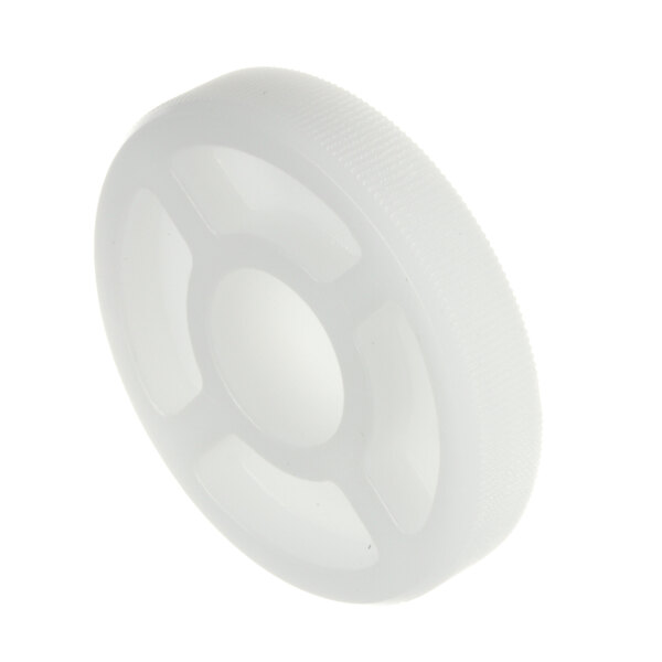A close-up of a white plastic wheel with a hole in the middle.